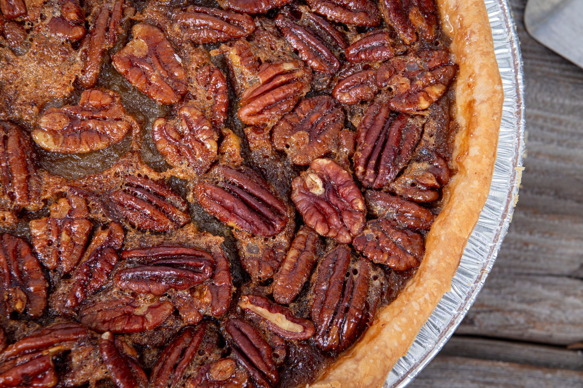 delicious pecan pie high angle view on wood table delicious pecan pie high angle view on wood table